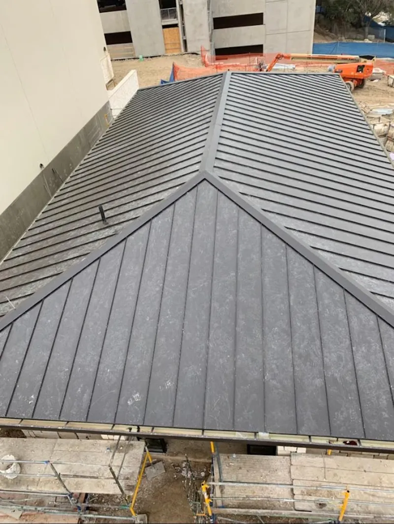 Commercial metal roof construction with crane equipment in Cherryland